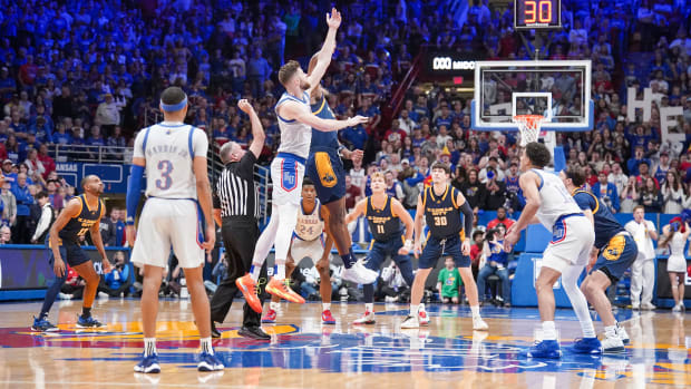 Dec 5, 2023; Lawrence, Kansas, USA; Kansas Jayhawks center Hunter Dickinson (1) and UMKC Kangaroos forward Allen David Mukeba Jr. (23) fight for the opening jump ball during the first half at Allen Fieldhouse. Mandatory Credit: Denny Medley-USA TODAY Sports  